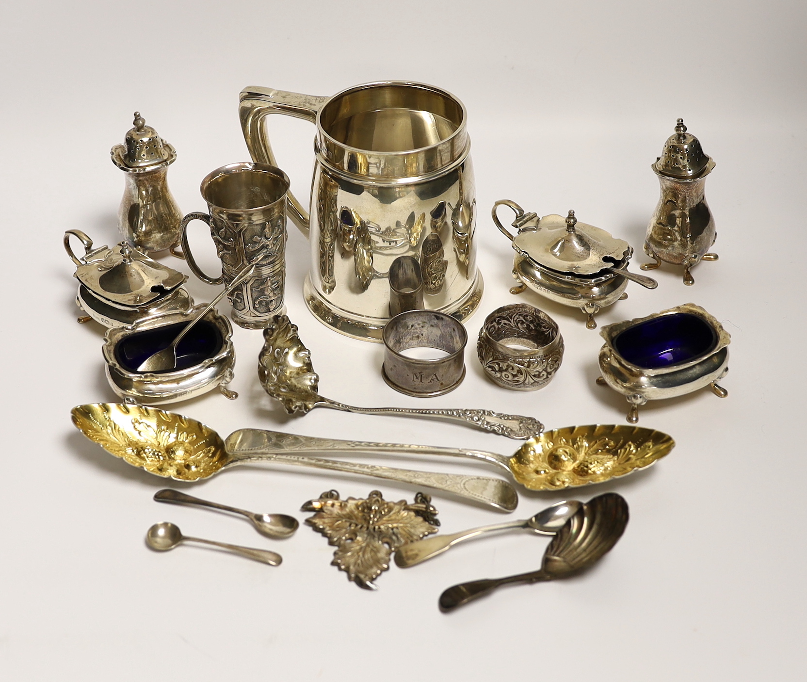 A George VI silver mug, Birmingham, 1937, 11.5cm with engraved inscription to Wing Commander E.E.M Angell, a pair of George III Old English pattern berry spoons, a George IV silver caddy spoons and other items including